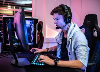 a man wearing a headset and using a computer